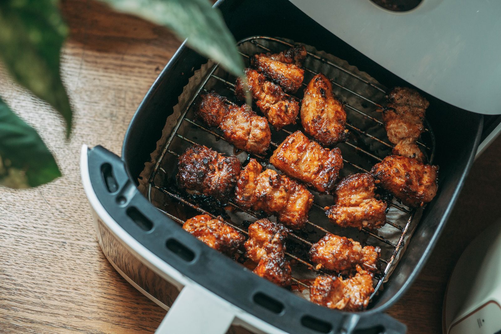 Airfryer på køkkenbord med sprød mad