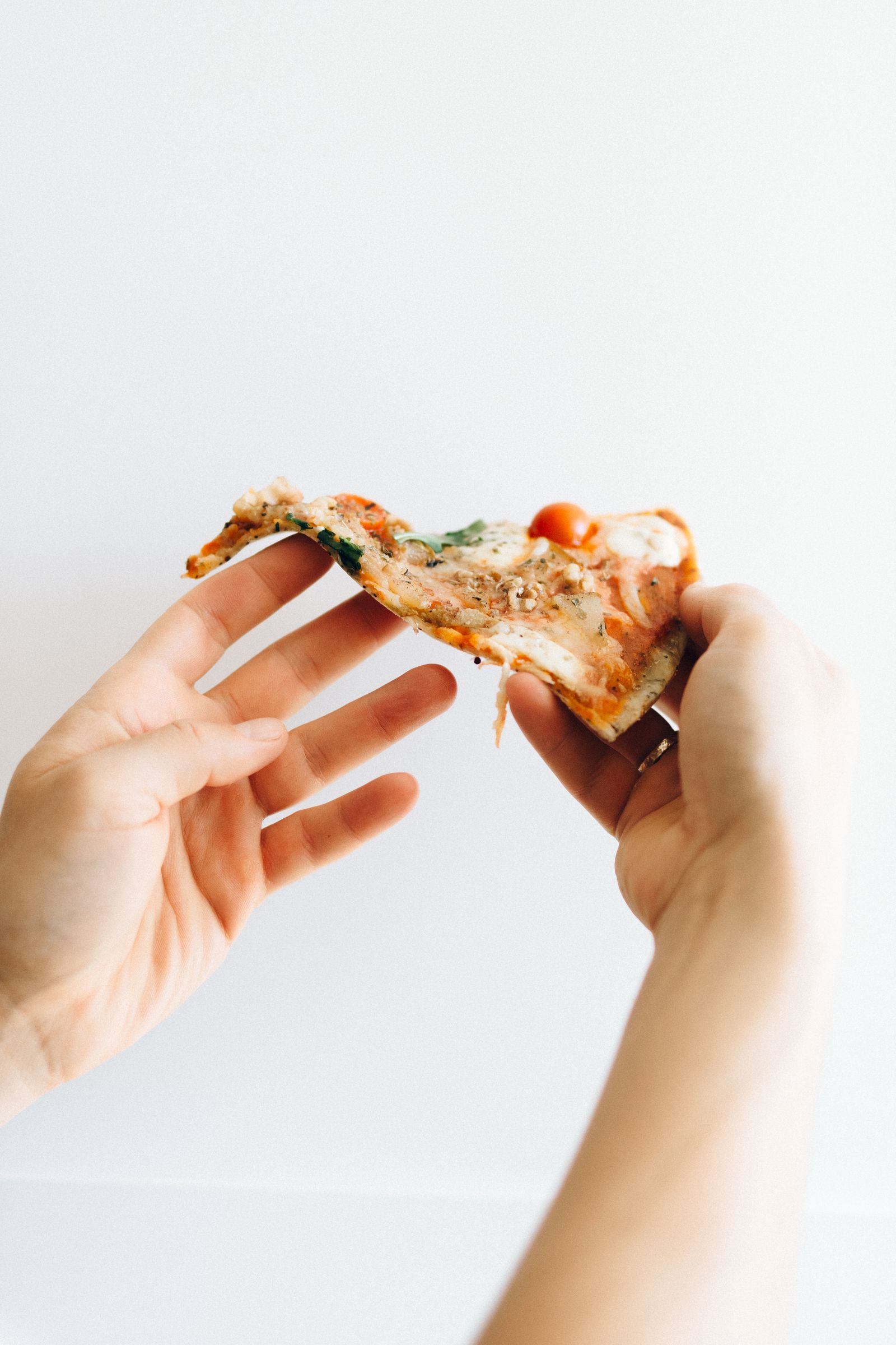 Pizzastykke med smeltet ost løftes